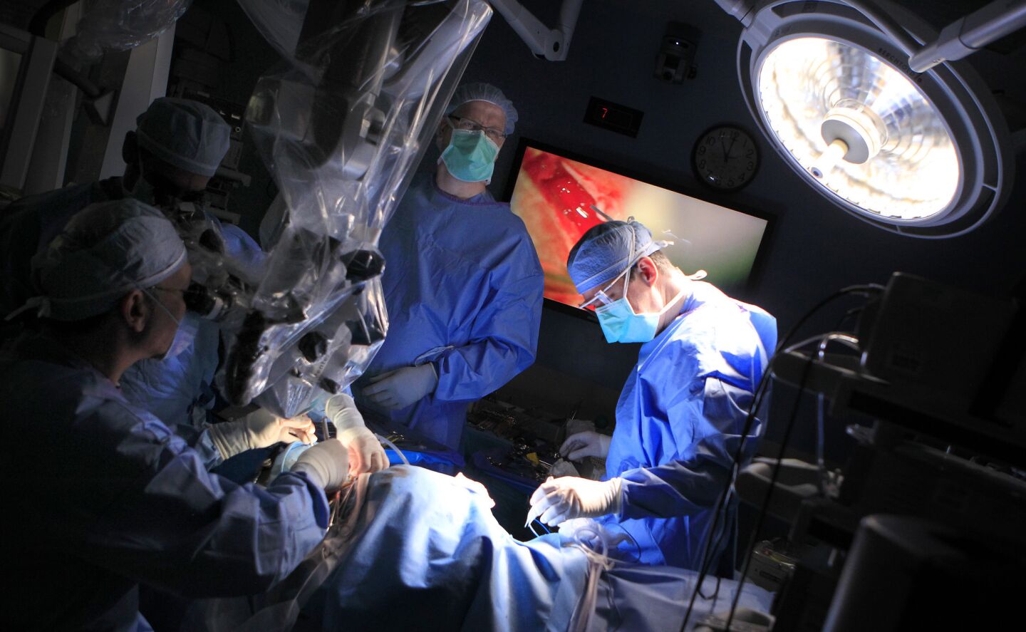 Surgeons and medical staff during Auguste Majkowski's auditory brainstem operation at Children's Hospital Los Angeles.