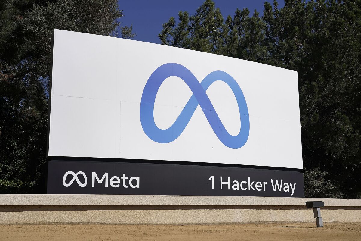FILE - Facebook's Meta logo sign is seen at the company headquarters in Menlo Park, Calif. on Oct. 28, 2021. Federal regulators open their campaign to block Facebook parent Meta’s acquisition of virtual-reality company Within Unlimited and its fitness app Supernatural, with opening arguments beginning Thursday, Dec. 8, 2022, in San Jose, California. (AP Photo/Tony Avelar, File)
