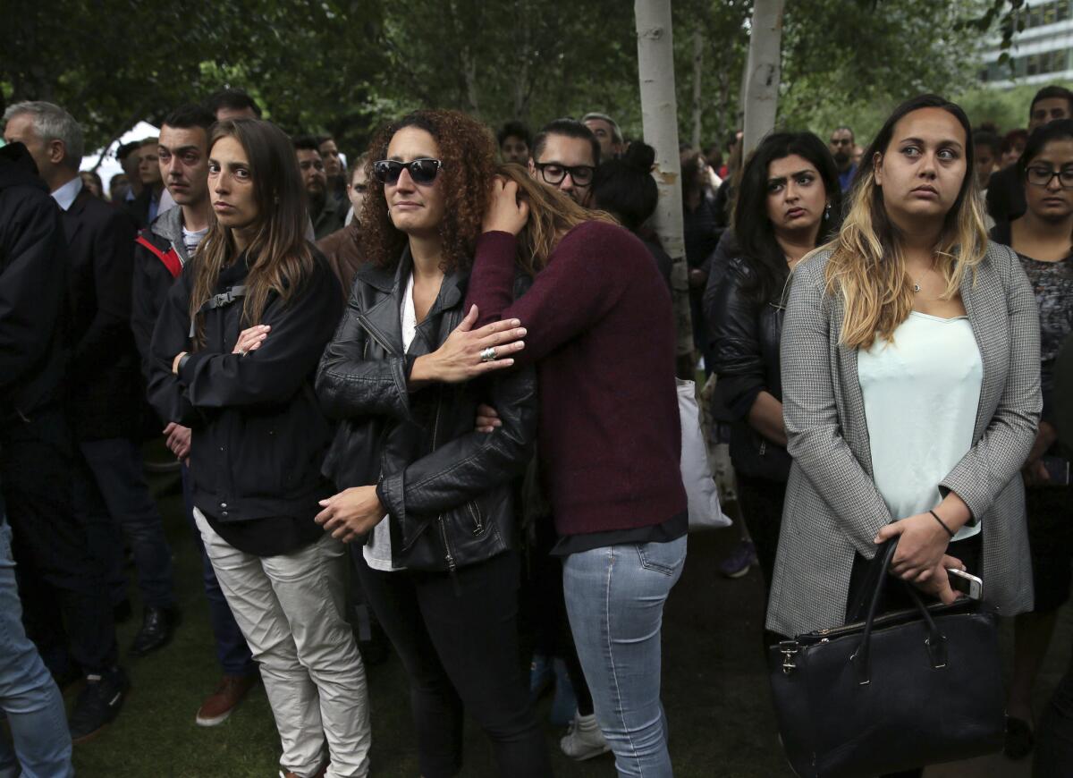 People attend a vigil for victims of Saturday's attack at Potters Fields Park in London.