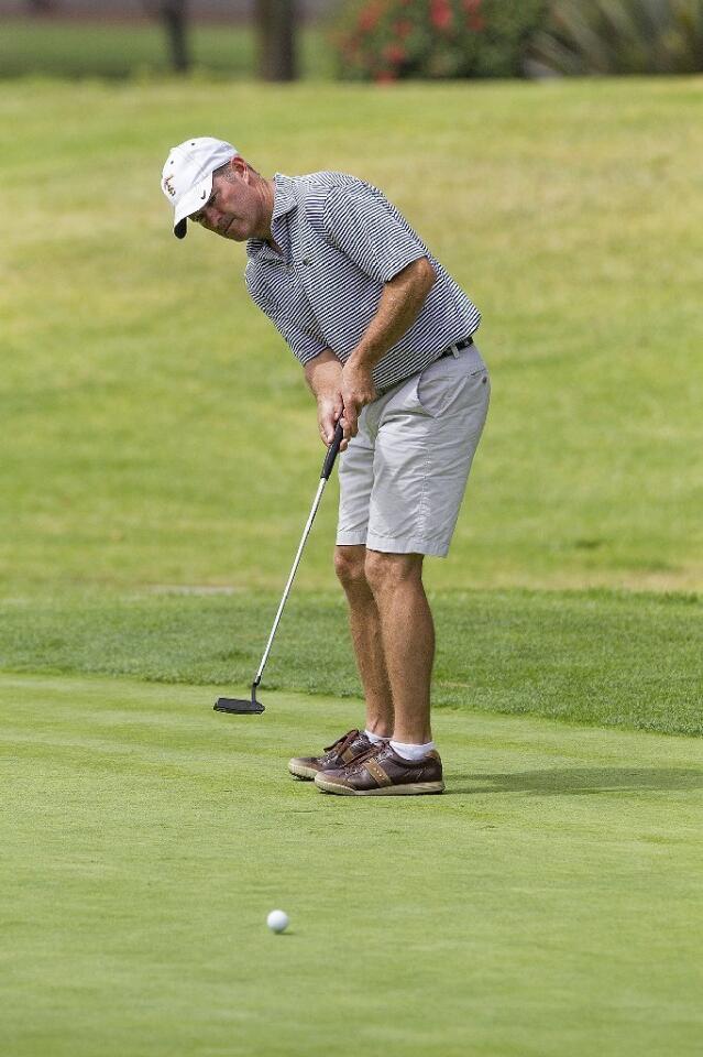 Will Tipton putts on the 16th green during the first of two rounds at the Costa Mesa City Men's Championship at Costa Mesa Country Club on Saturday.