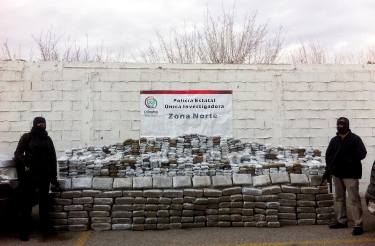 Mexican police officers stand guard next to 2 tons of seized marijuana in Ciudad Juarez, in Chihuahua state.