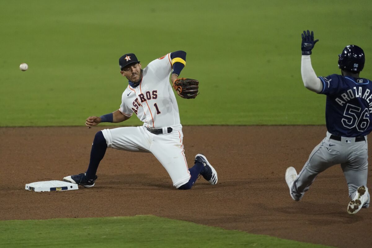Houston shortstop Carlos Correa misses a throw from Jose Altuve, allowing Tampa Bay's Randy Arozarena to be safe at second.
