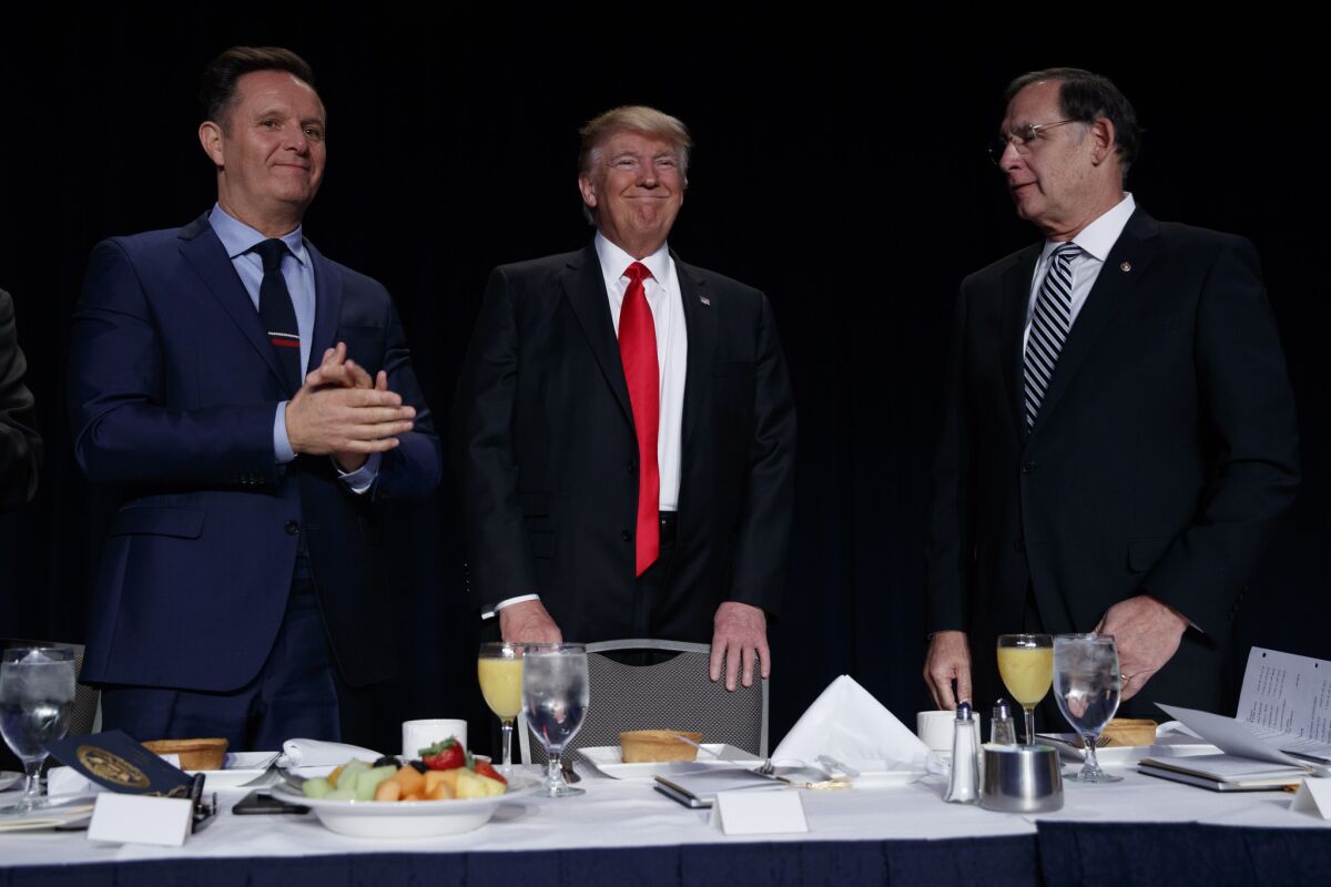 Television producer Mark Burnett, left, and Sen. John Boozman (R-Ark.) with President Trump at the National Prayer Breakfast on Thursday in Washington.