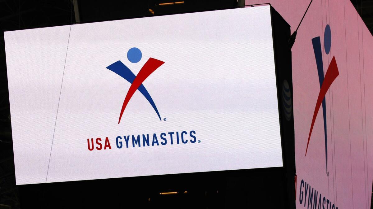 USA Gymnastics logo is displayed at AT&T Stadium during an news conference in Arlington, Texas. USA Gymnastics has filed a Chapter 11 bankruptcy petition as it attempts to reach settlements in the dozens of sex-abuse lawsuits it faces.