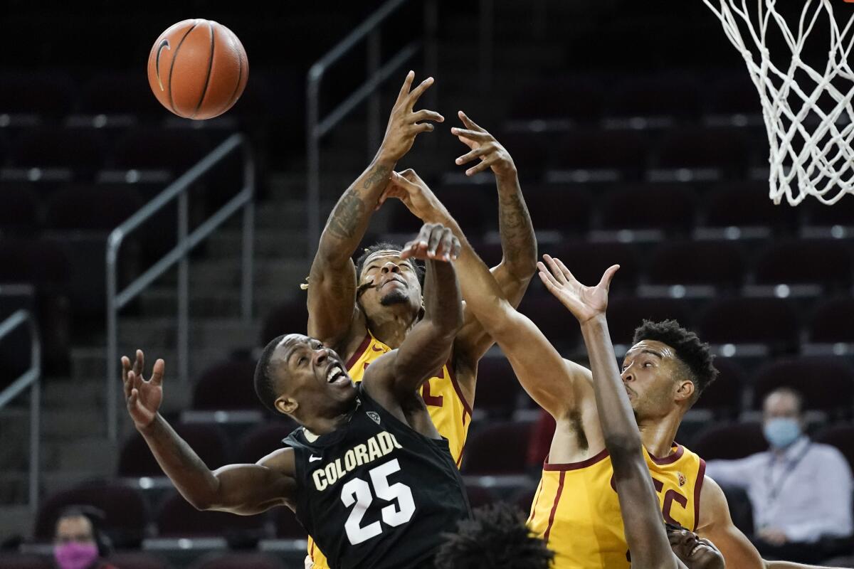 Colorado's McKinley Wright IV, bottom left, battles USC's Isaiah Mobley, right, and Isaiah White.