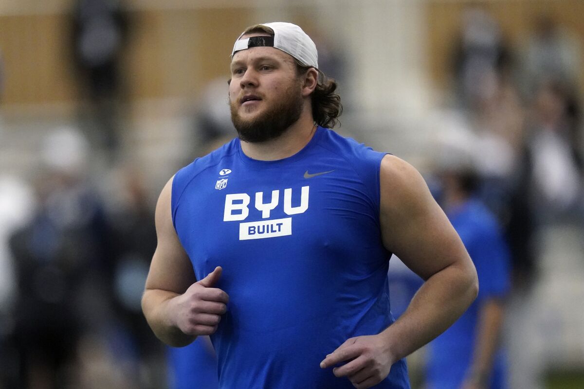 FILE - BYU offensive lineman Brady Christensen runs down field during the school's Pro Day football workout for NFL scouts in Provo, Utah, in this Friday, March 26, 2021, file photo. The Panthers are hoping 24-year Brady Christensen came help solidify the left tackle position that has been a revolving door ever since Jordan Gross retired nearly a decade ago. The third-round pick from BYU is looking to do the same. (AP Photo/Rick Bowmer, File)
