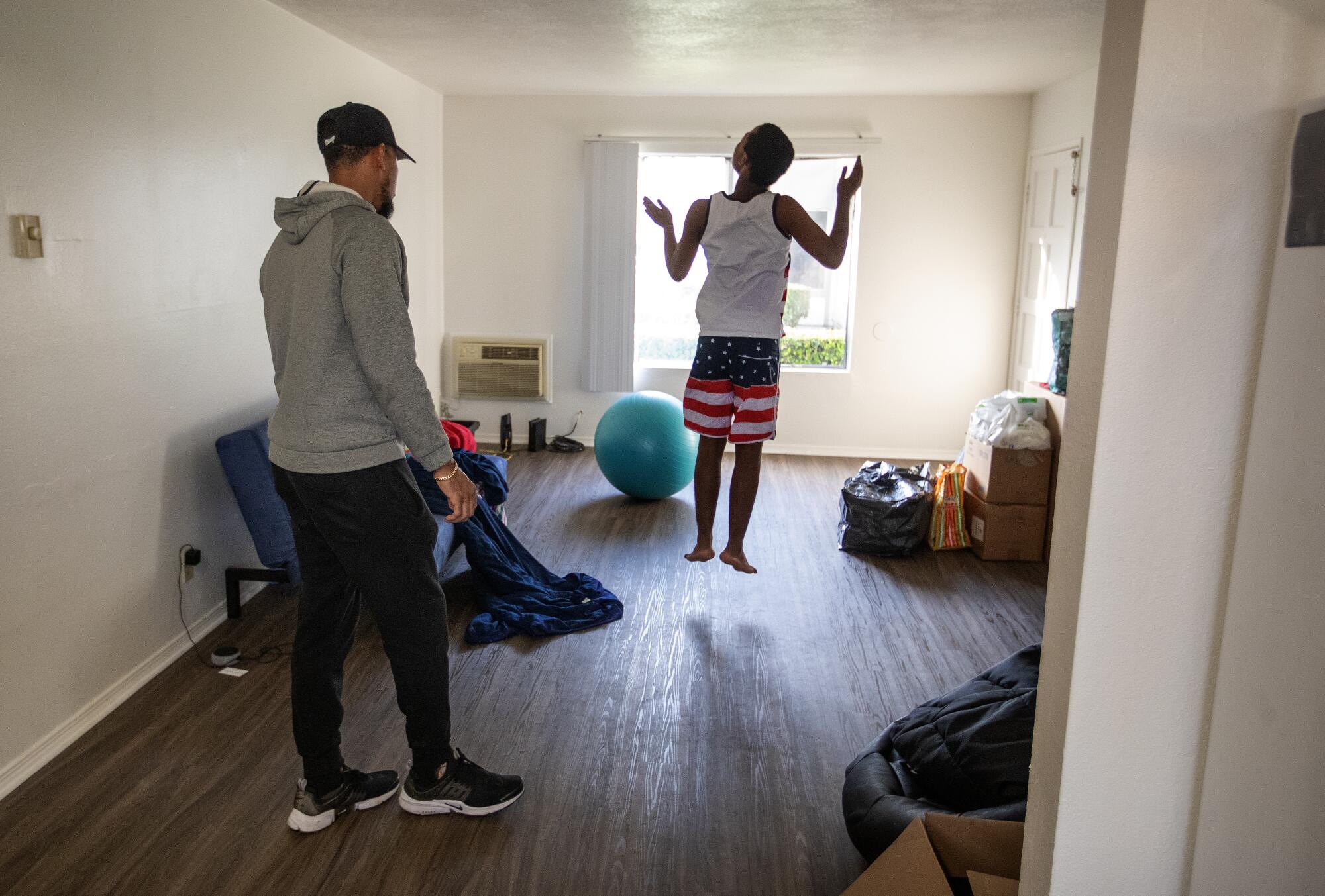 Noah leaps into the air while inside his home in Fullerton