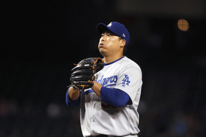 Los Angeles Dodgers starting pitcher Hyun-Jin Ryu, of South Korea, pauses on the mound during the first inning of the team's baseball game against the Arizona Diamondbacks on Thursday, Aug. 29, 2019, in Phoenix. (AP Photo/Ross D. Franklin)