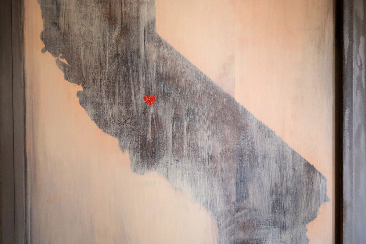 A painting of California in Christy Camara's home with a heart over Hanford.