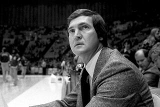 Jerry West, who was then the Lakers coach, sits on the sideline during a game in 1977. 