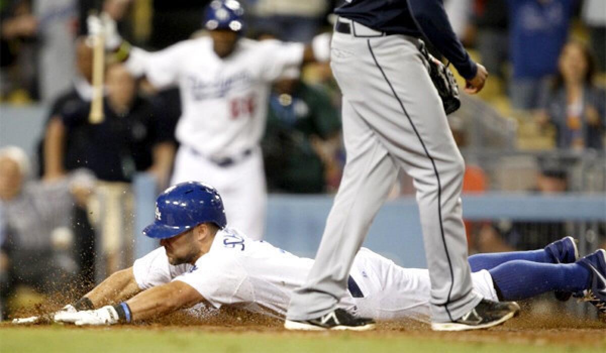 Skip Schumaker slides head-first into home plate on a wild pitch, giving the Dodgers a 2-1 victory in the 10th inning against the Atlanta Braves on Friday.