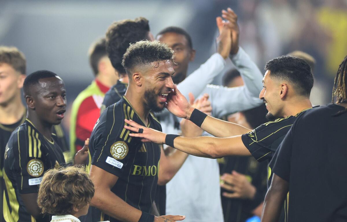 LAFC's Denis Bouanga celebrates with teammates after scoring late in a 2-1 win over Club América.