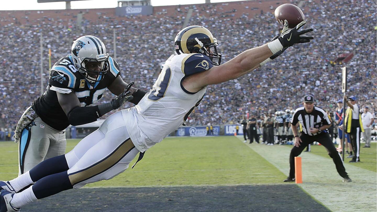 Rams tight end Tyler Higbee stretches out to catch, but misses, a pass in the end zone while he's defended by Panthers linebacker Thomas Davis during the second half.