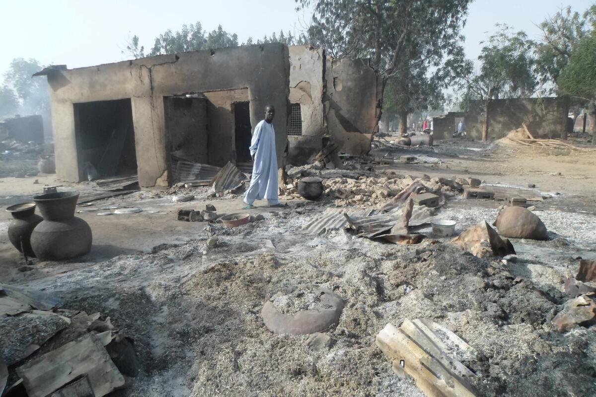 A man walks past burnt out houses following an attack by Boko Haram in Dalori village 3 miles from Maiduguri, Nigeria, on Sunday.