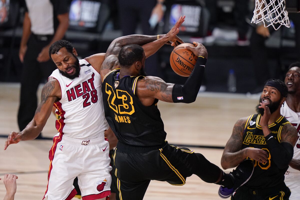 Miami guard Andre Iguodala battles for a rebound with Lakers forward LeBron James during Game 5.