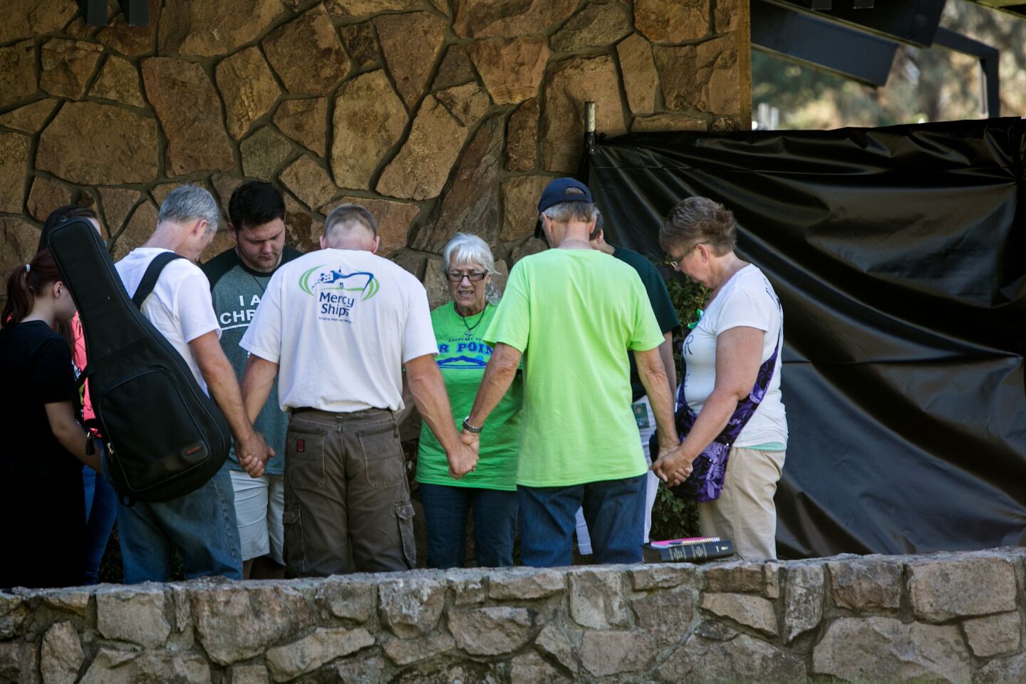 A prayer circle is held Oct. 5 at Snyder Hall, the site of the Umpqua Community College mass shooting.
