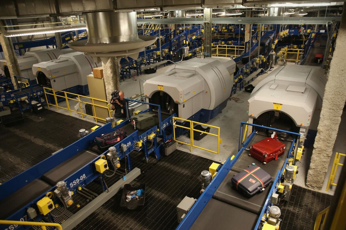 Luggage moves through a new explosives detection system at the Newark Liberty International Airport in New York City. The system gives all bags the same level of scrutiny.