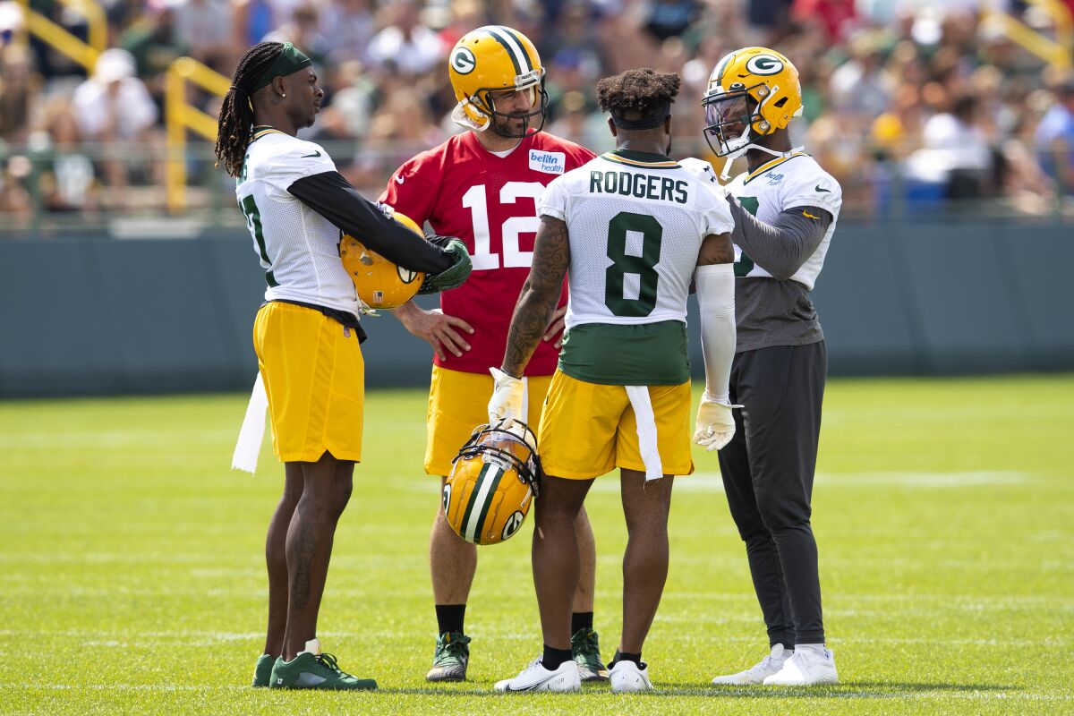 FILE - Green Bay Packers' Davante Adams, left, Aaron Rodgers (12), Amari Rodgers (8) and Randall Cobb talk during an NFL football training camp practice at Ray Nitschke Field in Green Bay, Wisc., in this Monday, Aug. 2, 2021, file photo. Cobb, who previously played for the Packers from 2011-18, returned to Green Bay at the start of training camp in a trade that sent an undisclosed draft pick to the Houston Texans. (Samantha Madar/The Post-Crescent via AP, File)/