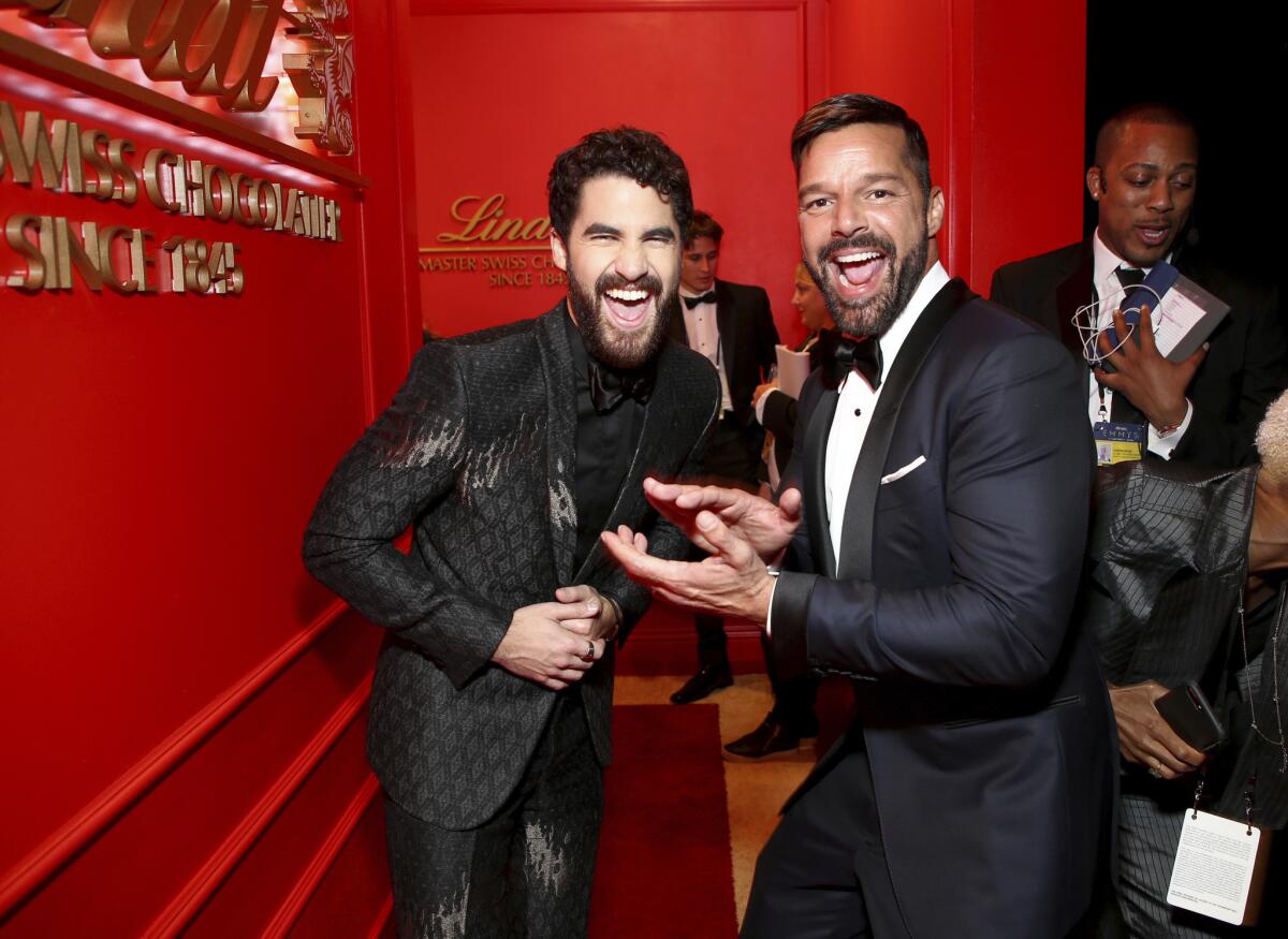 Darren Criss, left, and Ricky Martin pose in the Lindt Chocolate Lounge at the 70th Primetime Emmy Awards on Monday, Sept. 17, 2018, at the Microsoft Theater in Los Angeles.