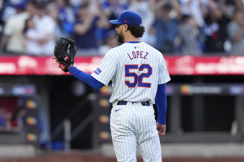 New York Mets pitcher Jorge López (52) reacts after Los Angeles Dodgers' Shohei Ohtani hit a two-run home run 