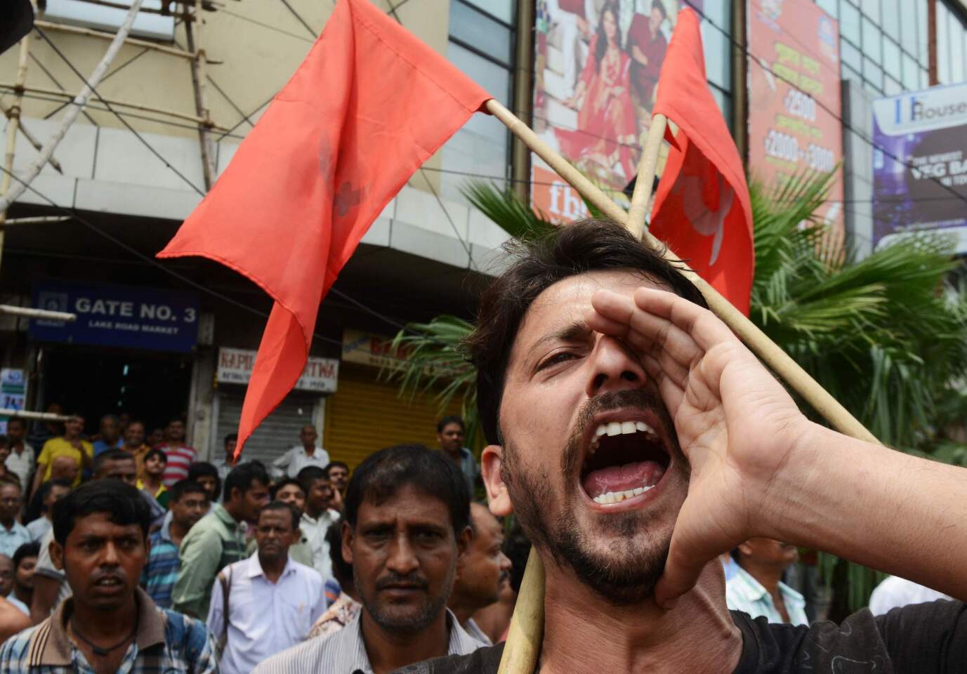 Indian activists shout slogans during a rally in Kolkata, supporting the nationwide strike called by 10 major trade unions over wages and economic reforms. Millions of public-sector workers went on strike across India protesting against Prime Minister Narendra Modi's plans for greater privatization and a proposed minimum wage increase they say is inadequate.