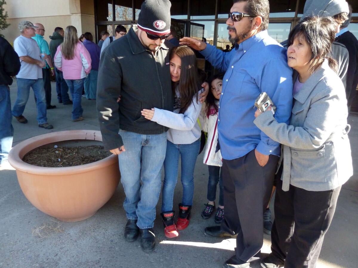 Parents gather in January at a Roswell, N.M., mall to meet their children after a shooting at a middle school.