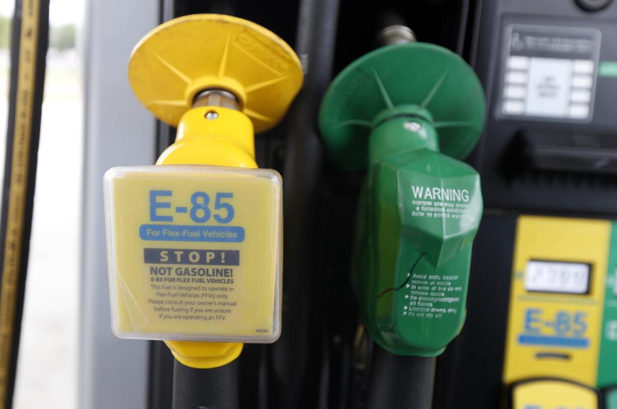 A fuel nozzle for E-85, left, and traditional gasoline is seen at a gas station in Batesville, Miss. in August of 2014. The Obama administration is boosting the amount of corn-based ethanol and other renewable fuels in the U.S. gasoline supply.