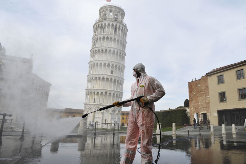 PISA, ITALY - MARCH 17: A worker carries out sanitation operations for the Coronavirus emergency in Piazza dei Miracoli near to the Tower of Pisa in a deserted town on March 17, 2020 in Pisa, Italy. The sanitization service is carried out by four teams in all the districts of the city of Pisa, to sanitize the squares, streets, public areas, sidewalks, surfaces exposed to the contact of large flows of people. Italian government has imposed unprecedented restrictions on its 60 million people as it expanded its emergency Coronavirus (Covid-19) lockdown nationwide. The number of confirmed Covid-19 cases in Italy has passed 31,500 with the death toll rising to 2503. (Photo by Laura Lezza/Getty Images)