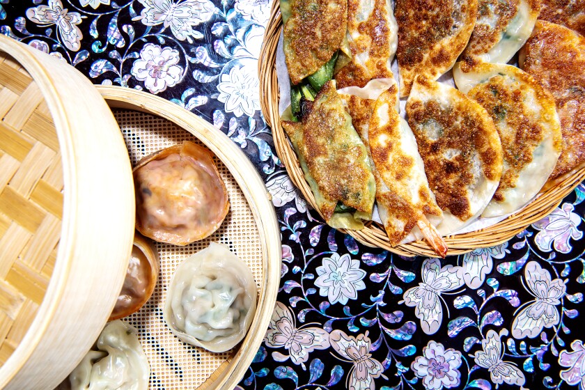 Steamed mandu plate, left, and the Mandu sampler from CHD in Koreatown.
