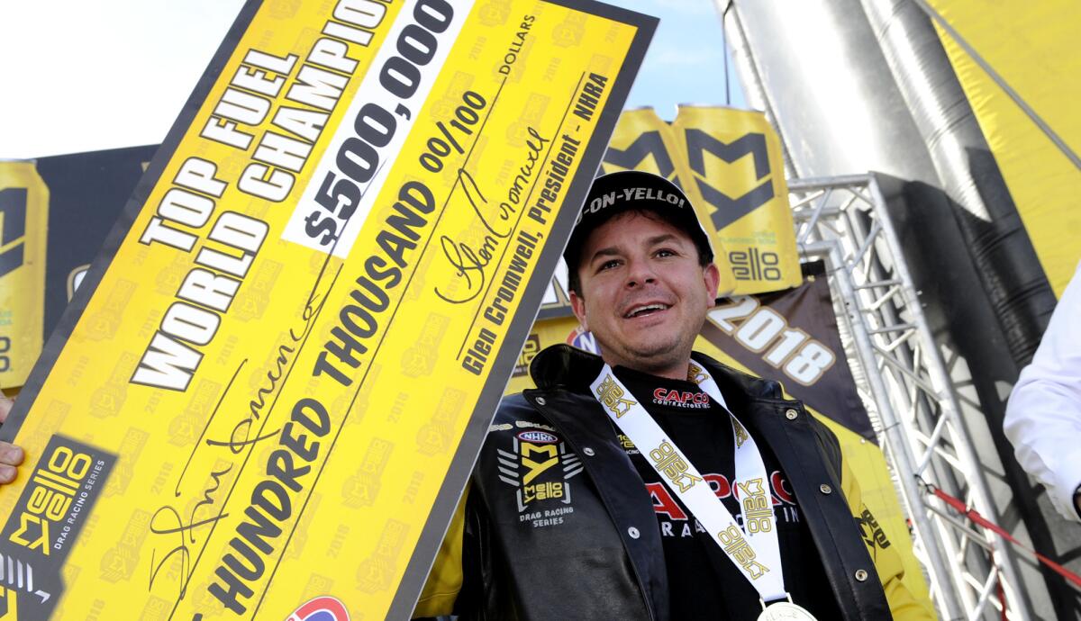 Steve Torrence poses for pictures after winning his first top fuel series title at Las Vegas Motor Speedway on Oct. 28.