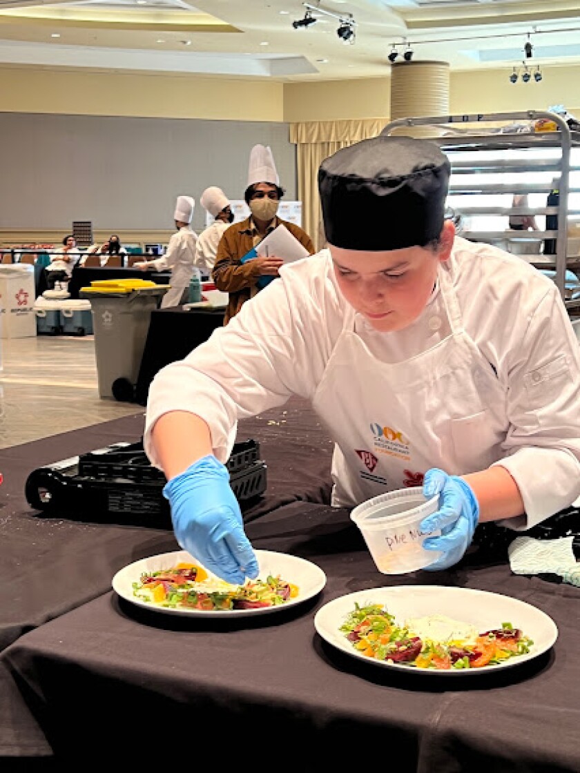 NHHS junior Jeffrey Dangl prepares a citrus and fennel salad Monday at the CA ProStart Cup in Long Beach.