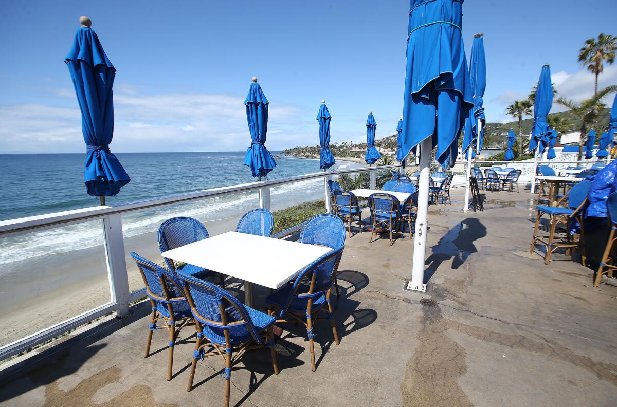 The Cliff, an outdoor restaurant and music venue in Laguna Beach, is empty of patrons on the view deck as restaurants around the region comply with orders to stop dine-in service during the coronavirus outbreak.