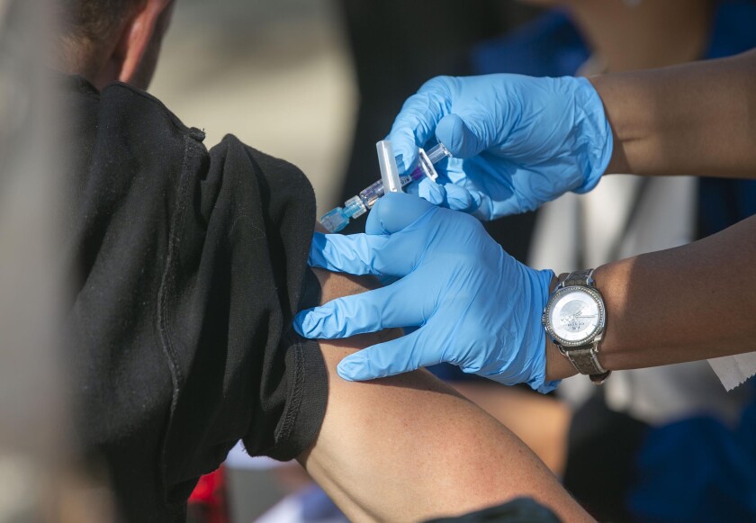 A man receives a flu vaccine shot in Spring Valley, Calif., in 2019.