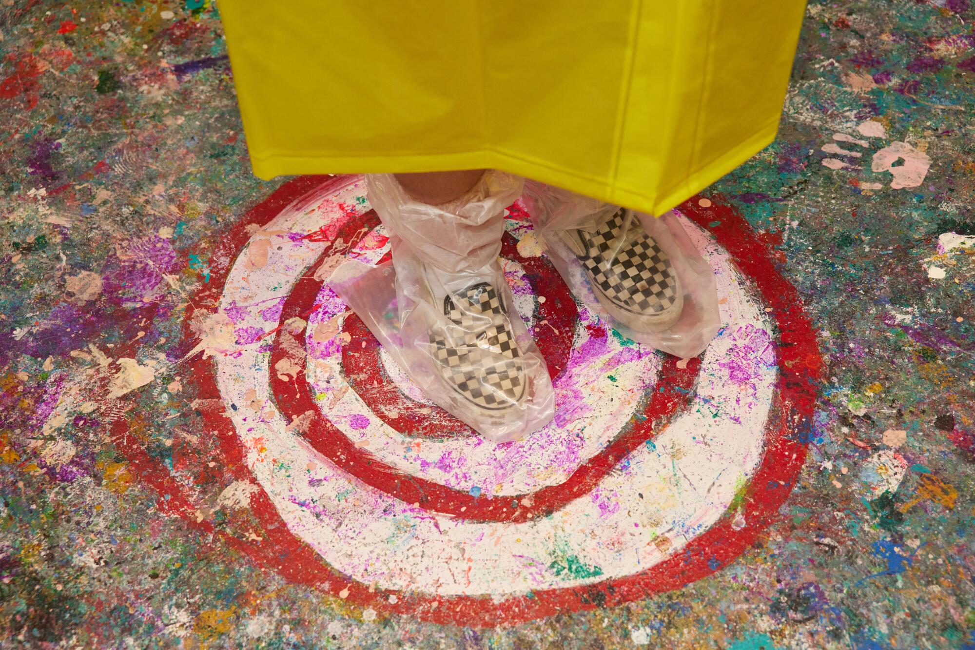 A pair of feet, standing atop a painted target on the floor.