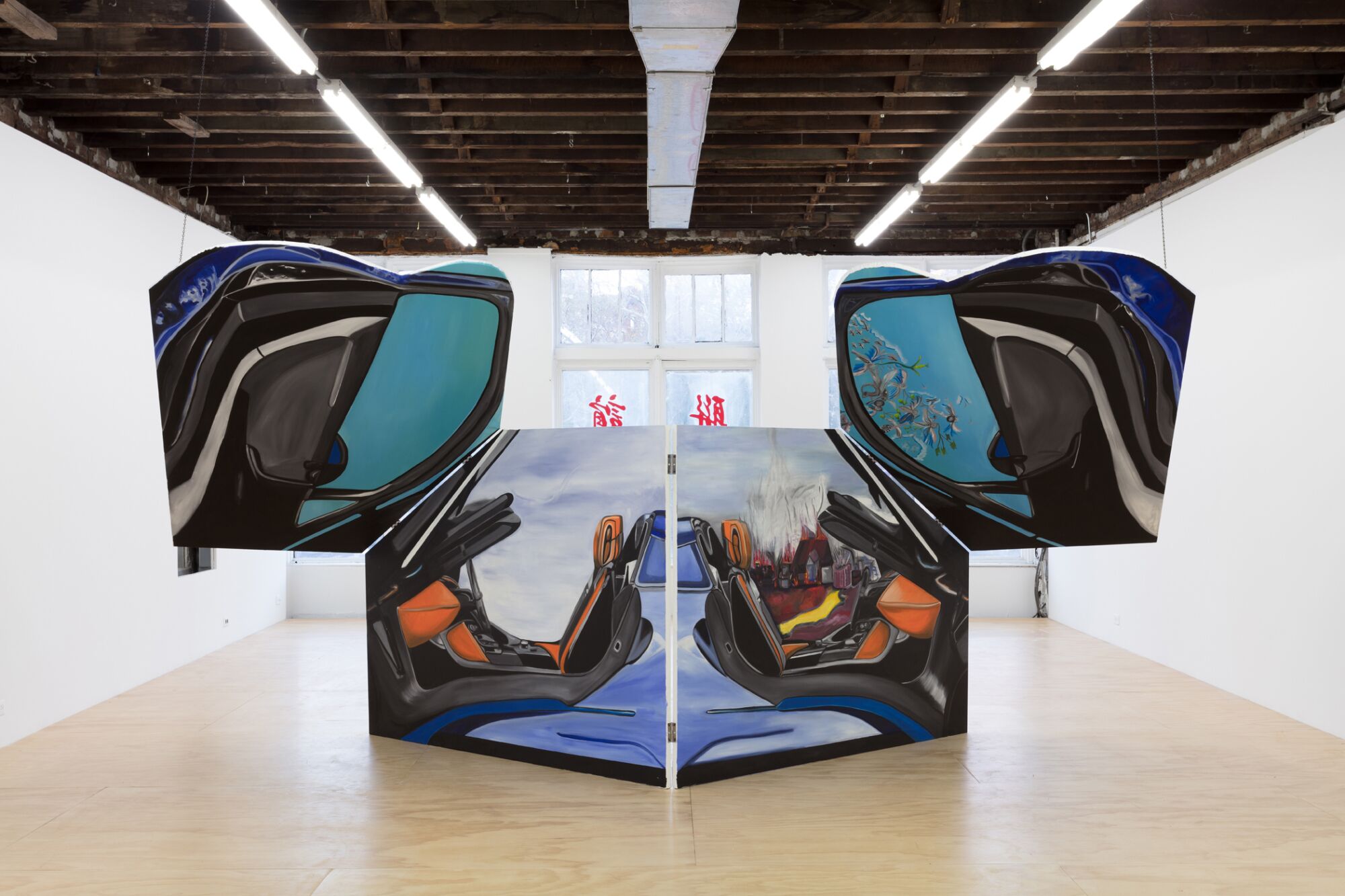 Four canvases hinged to one another evoke the interior of a sports car with winged doors.