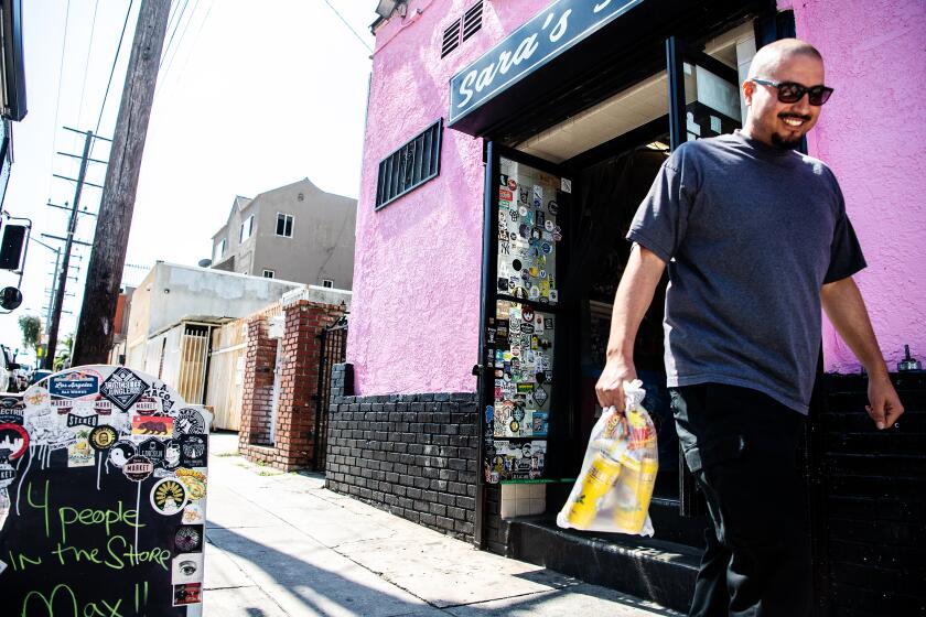 LOS ANGELES, CA- April 1, 2020: David Ramirez, longtime customer of Sara's Market, leaves with his purchase on Wednesday, April 1, 2020. (Mariah Tauger / Los Angeles Times)