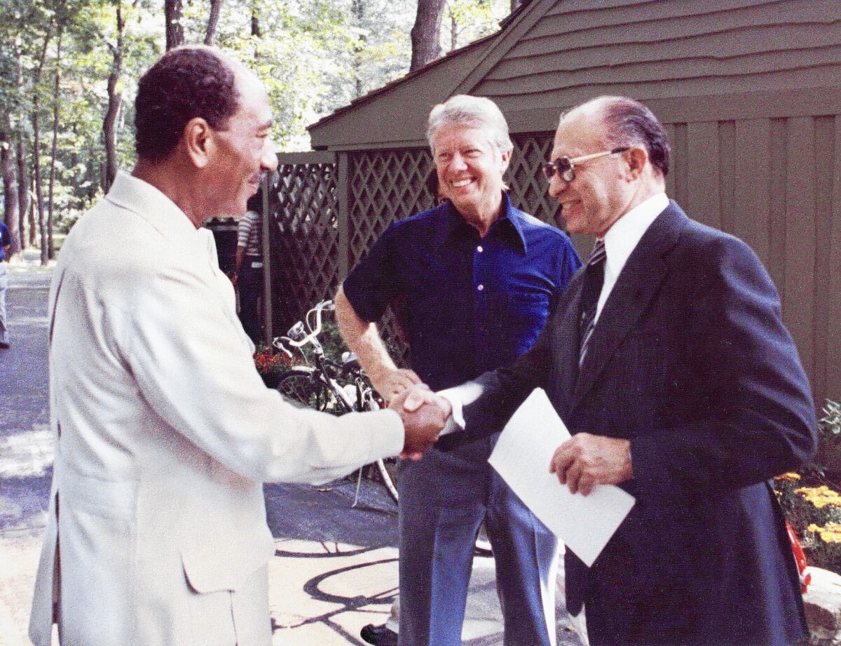 Egyptian President Anwar Sadat, left, shakes hands with Israeli Premier Menachem Begin after meetings at Camp David with President Jimmy Carter in 1978.