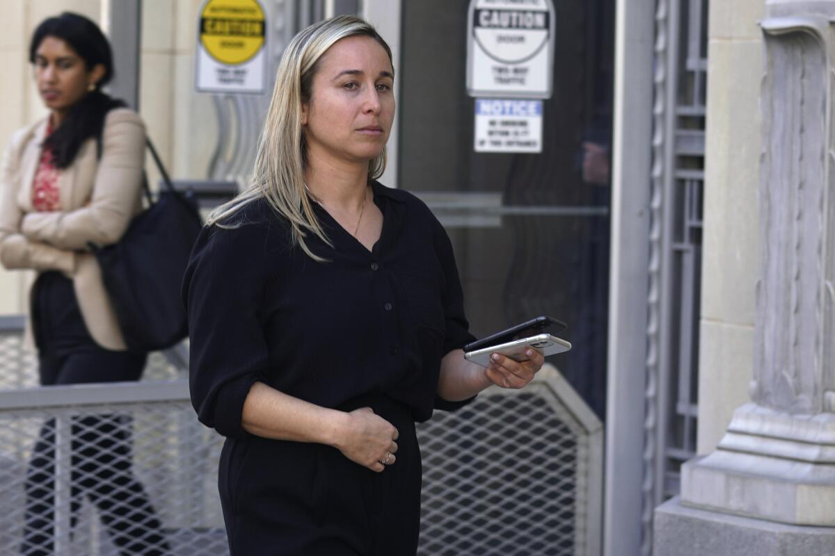 Carli Skaggs, the wife of Tyler Skaggs, walks out of a federal court building after testifying in Fort Worth on Tuesday.