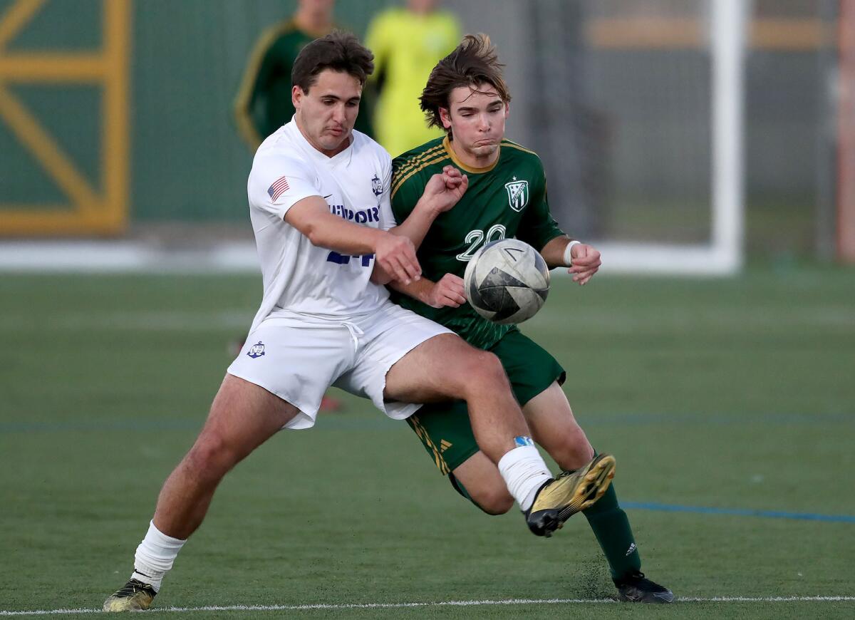 Newport Harbor's Eduardo Hopkin tries to control a pass as Edison's Bradley Schmidt marks him, from left, on Monday.