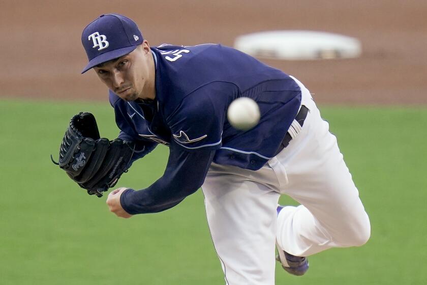 Tampa Bay Rays pitcher Blake Snell (4) delivers against New York Yankees' DJ LeMahieu during the first inning in Game one of a baseball American League Division Series Monday, Oct. 5, 2020, in San Diego. (AP Photo/Jae C. Hong)