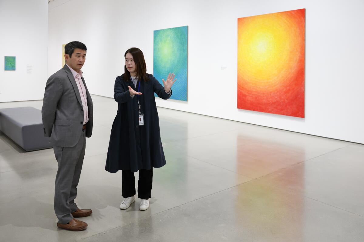 State Sen. Dave Min (D-Irvine) tours OCMA’s Jennifer Guidi exhibition, “And so it is.” 
