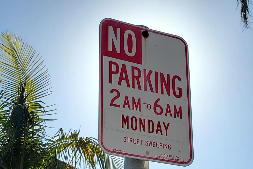 Some La Jolla streets have signs requiring cars to be moved on sweeping days.