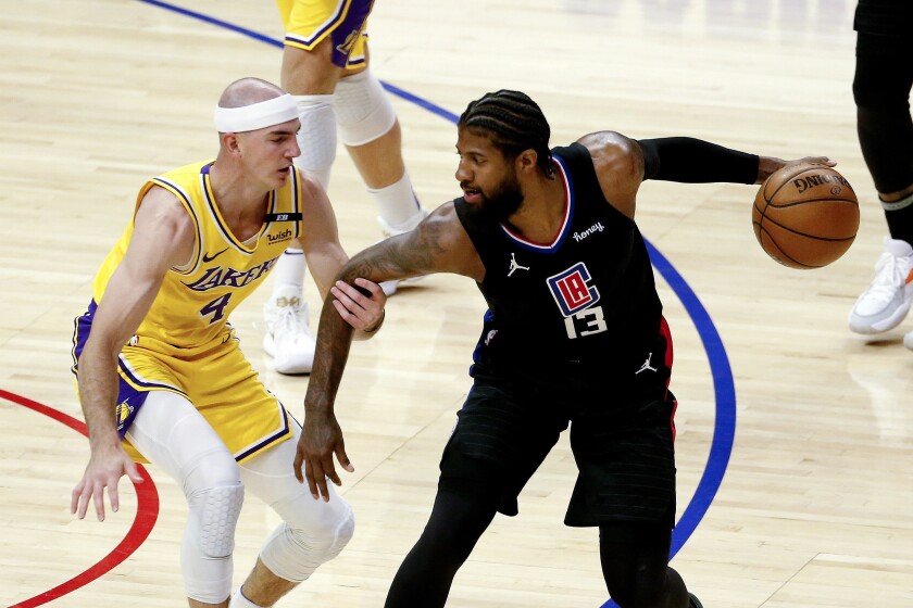 Los Angeles Clippers' Paul George (13) is defended by Los Angeles Lakers' Alex Caruso (4) during the first half of an NBA basketball game Thursday, May 6, 2021, in Los Angeles. (AP Photo/Ringo H.W. Chiu)