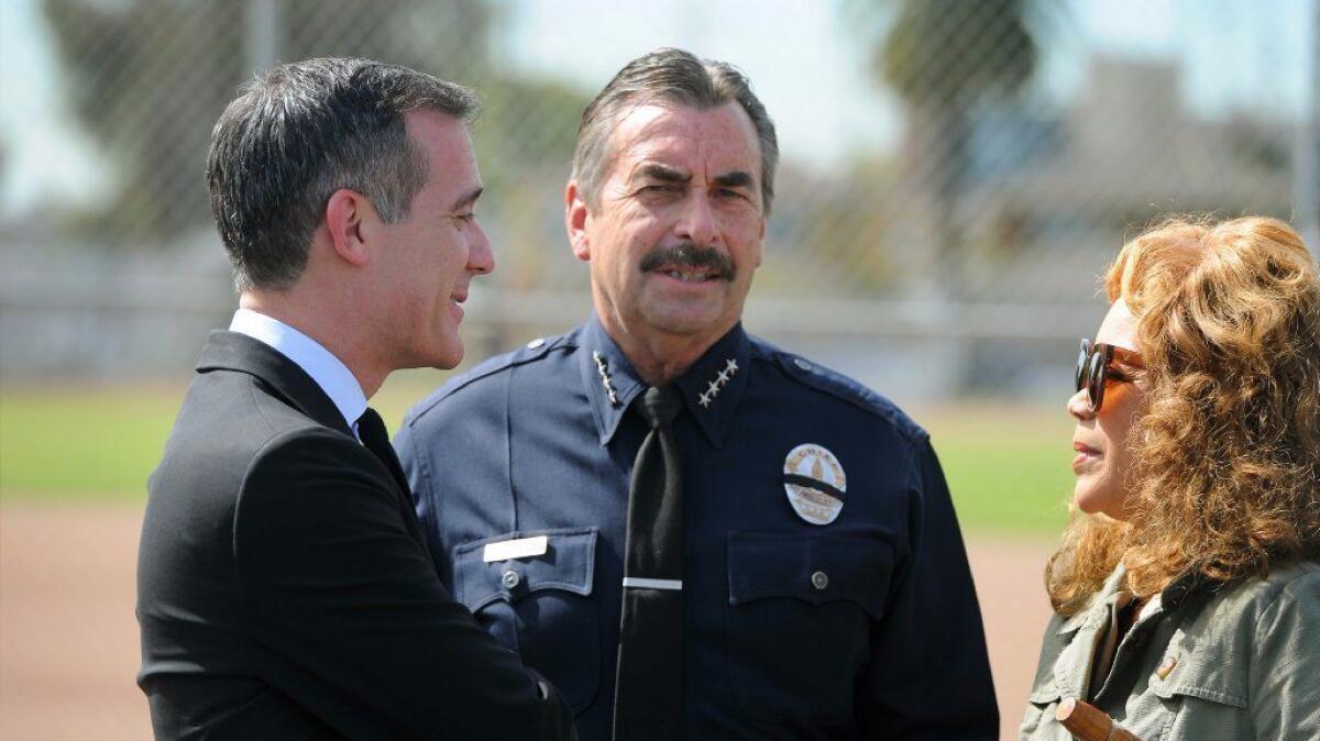 LAPD Chief Charlie Beck, center, said Tuesday that reports of sexual assault and domestic violence among the city's Hispanic population have dropped this year, as a climate of fear grips the city's immigrant population.