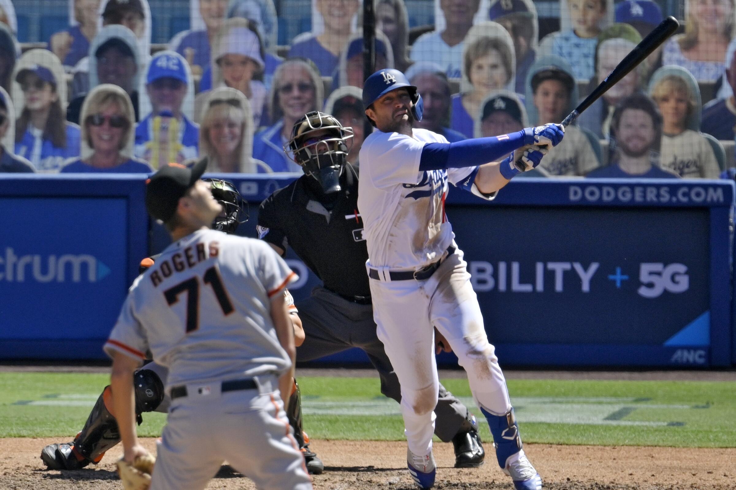 Dodgers' AJ Pollock watches his three-run home run off San Francisco Giants relief pitcher Tyler Rogers.