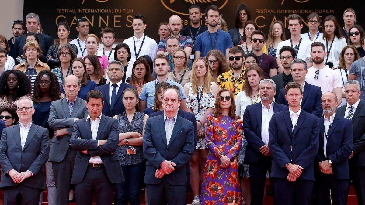 A moment of silence at Cannes for Manchester: Front row, from left, festival director Thierry Fremaux, Cannes Mayor David Lisnard, festival President Pierre Lescure, actress Isabelle Huppert and staff.