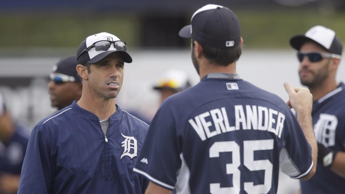 Detroit Tigers manager Brad Ausmus chats with starting pitcher Justin Verlander before a spring-training game in 2015.