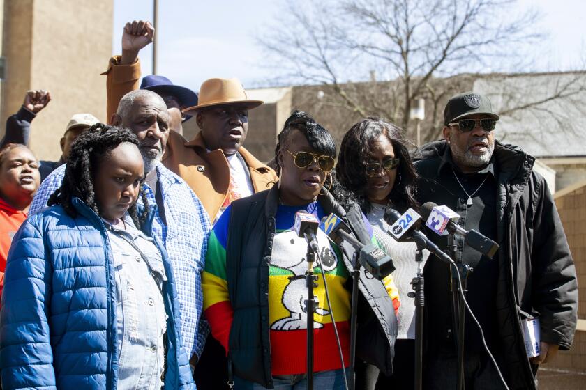 FILE - Gershun Freeman's family, attorney Ben Crump, and RowVaughn and Rodney Wells, the parents of Tyre Nichols, hold a press conference to address Freeman's death at Shelby County Jail outside of the Shelby County Criminal Justice Center in Memphis, Tenn., March 17, 2023. Nine Memphis jail deputies have been indicted in the death of Freeman, who was having a psychotic episode and died in custody last fall after jailers punched, kicked and kneeled on his back during a confrontation, a sheriff said Wednesday, Sept. 20. (Chris Day/The Commercial Appeal via AP, File)