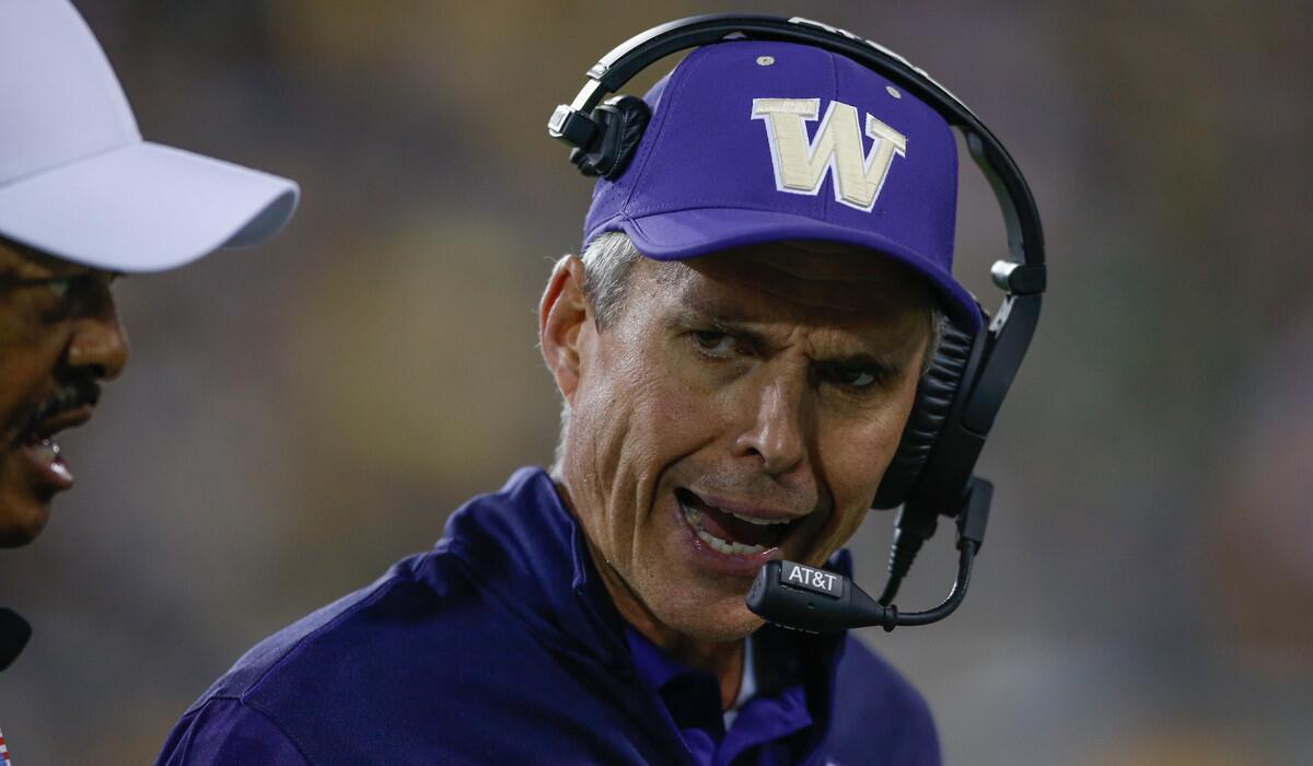 Washington Coach Chris Petersen talks to the referee during the game against Oregon on Saturday.