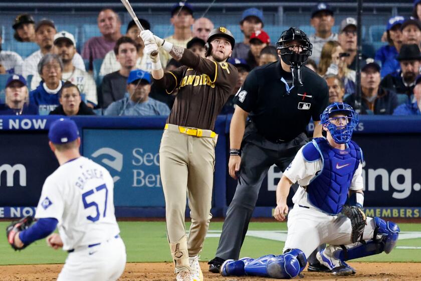 LOS ANGELES, CALIFORNIA - OCTOBER 06: Jackson Merrill #3 of the San Diego Padres hits a two-run.